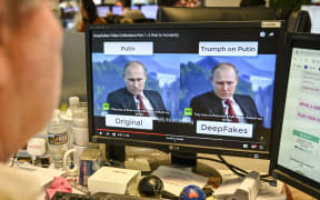 A AFP journalist views a video on January 25, 2019, manipulated with artificial intelligence to potentially deceive viewers, or "deepfake" at his newsdesk in Washington, DC.