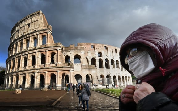 Italy's popular tourist spots like the Colosseum in Rome are nearly deserted as a nationwide ban on public gatherings takes effect.