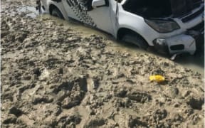 The two men slept on the roof of their car after they spotted a crocodile.