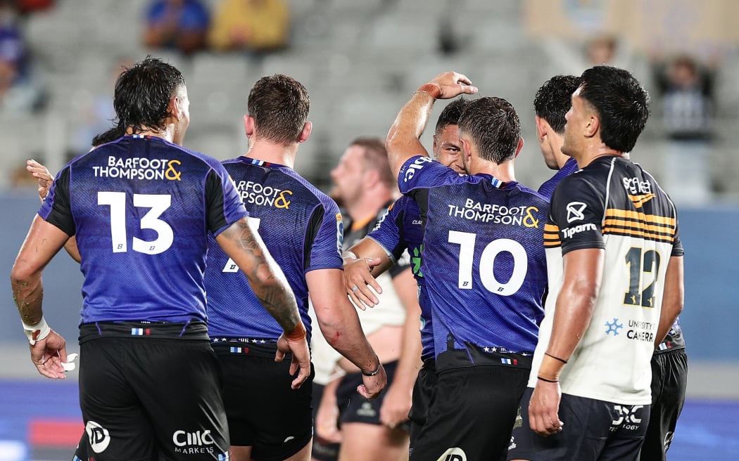 Caleb Clarke celebrates with his Blues teammates.
