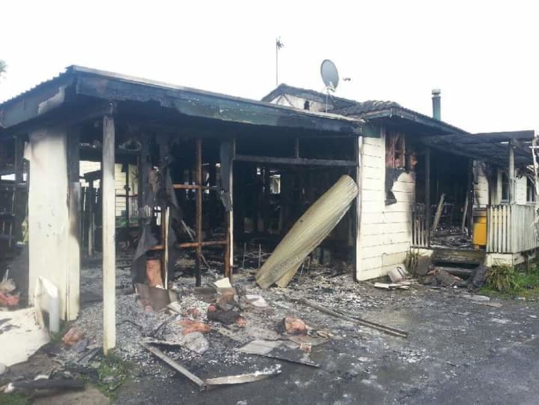 The gutted remains of the Awa Street house. Eight people escaped the fire.