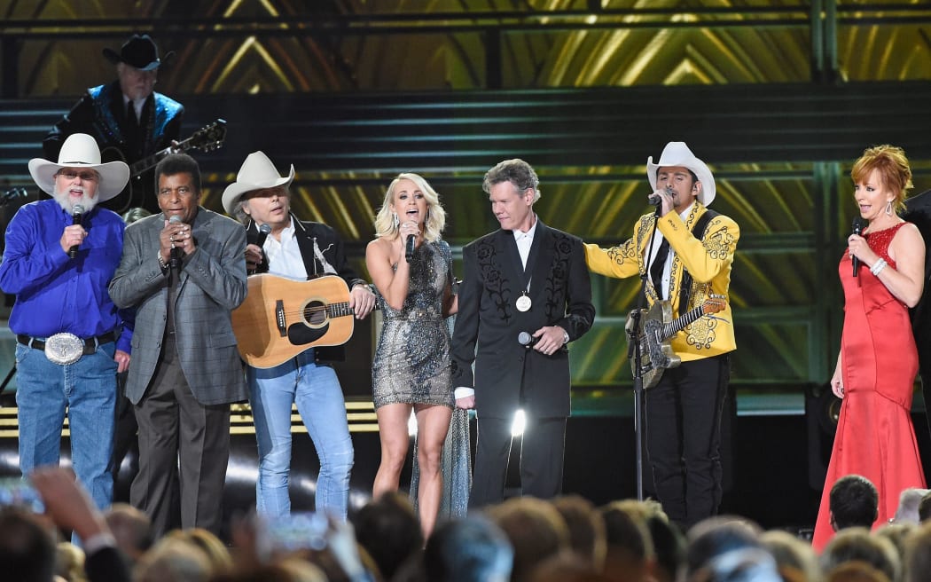 NASHVILLE, TN - NOVEMBER 02: (L-R) Charlie Daniels, Charley Pride, Dwight Yoakam, Carrie Underwood, Randy Travis, Brad Paisley, Reba McEntire,  perform onstage at the 50th annual CMA Awards at the Bridgestone Arena on November 2, 2016 in Nashville, Tennessee.