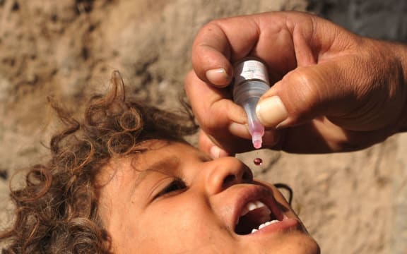 A child is immunised against the disease.