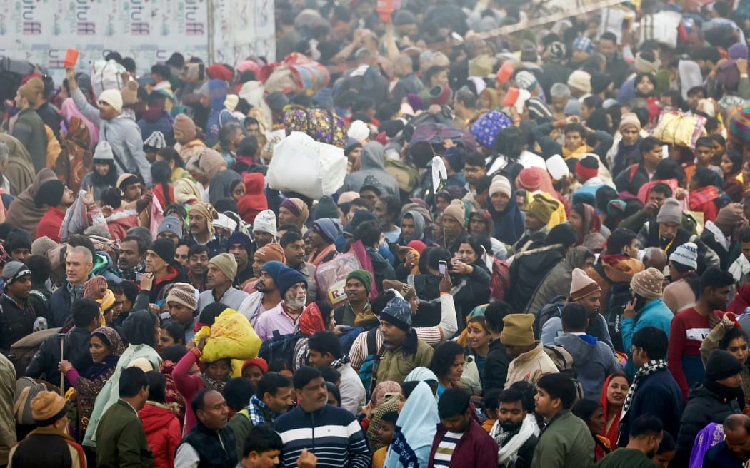Hindu pilgrims arrive to take a dip in Sangam, the confluence of Ganges, Yamuna and mythical Saraswati rivers, during the Maha Kumbh Mela festival, on a cold winter morning in Prayagraj on January 13, 2025. Vast crowds of Hindu pilgrims in India began bathing in sacred waters on January 13, as the Kumbh Mela festival opened, with organisers expecting 400 million people -- the largest gathering of humanity.