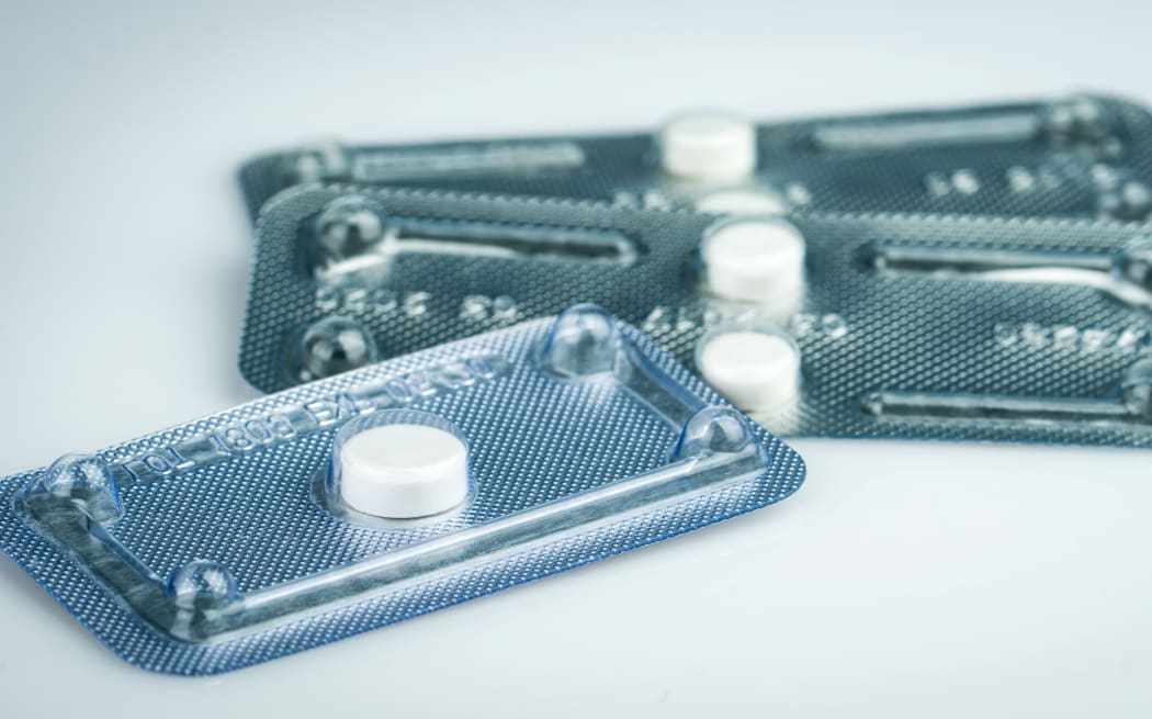 Emergency contraceptive pills in blister pack on blurred background of morning after pills.
