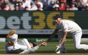 England's Jacob Bethell (left) drops a catch on the first day of the fourth Ashes cricket Test match between Australia and England at the Melbourne Cricket Ground on 26 December, 2025.