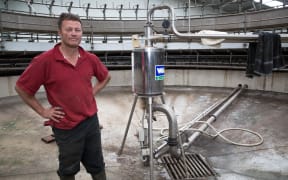 Simon Mackle stands inside his milking shed which is now back operational, but with no water to clean the shed, and no road out of Kaikoura still, all milk is being tipped down the drain.