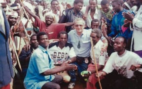 Bob Askew with new friends and a young Francois Byanama (in white, sitting first from the right) and others at the camp in Goma, DRC,1994