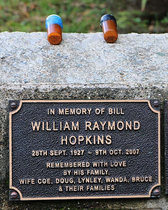 An image of vials of human ashes above a plaque commemorating Bruce Hopkins father Bill.