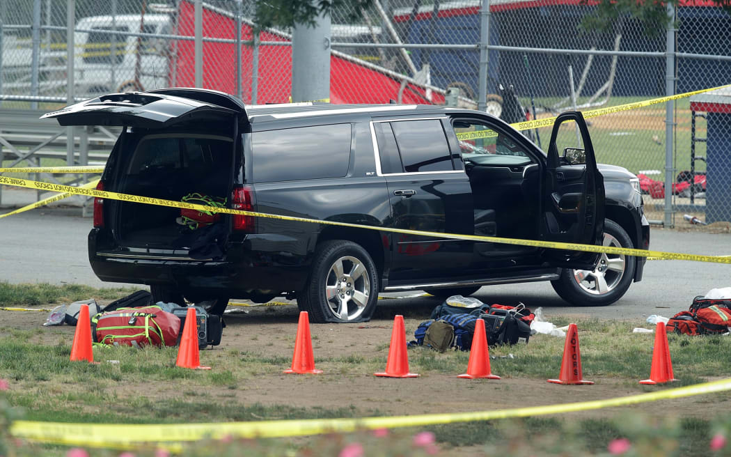 A black SUV with a shot-out windscreen at  the scene of the shooting.