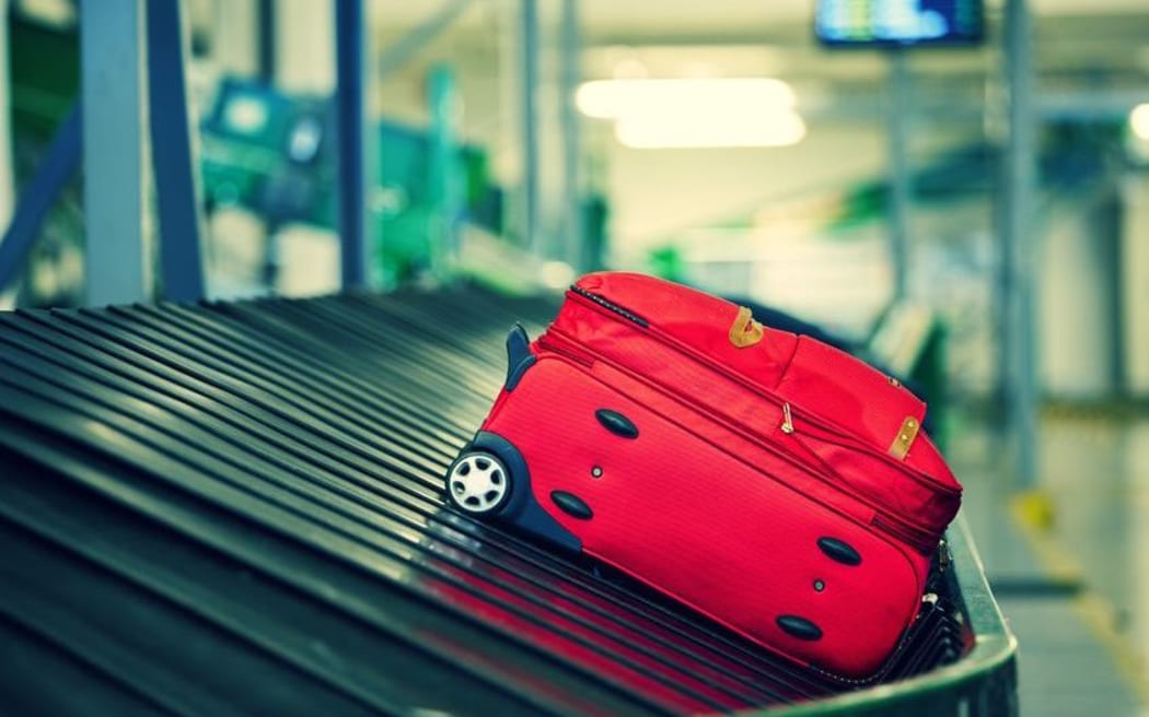 Luggage on airport carousel.