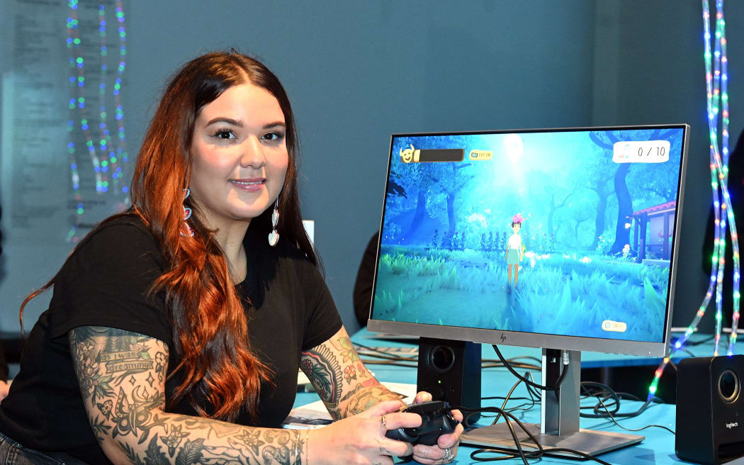 Game developer Elaine Gomez of Puerto Rico demonstrates a game she has developed called Vejigantes at the opening of Whare Kariori - International Indigenous Digital gaming summit at the Otago Museum