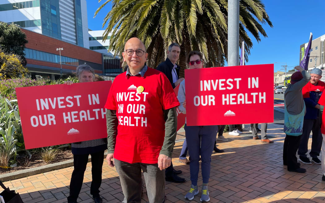 Doctors supported by nurses picket Wellington hospital. ASMS president Julian Vyas says extra spaces in med schools will take five years before new students are junior doctors and 15 before they become specialists.