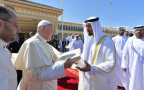 Pope Francis gifts Abu Dhabi's Crown Prince Mohammed bin Zayed al-Nahyan a copy of the Human Fraternity document ahead of boarding his plane on February 5, 2019.