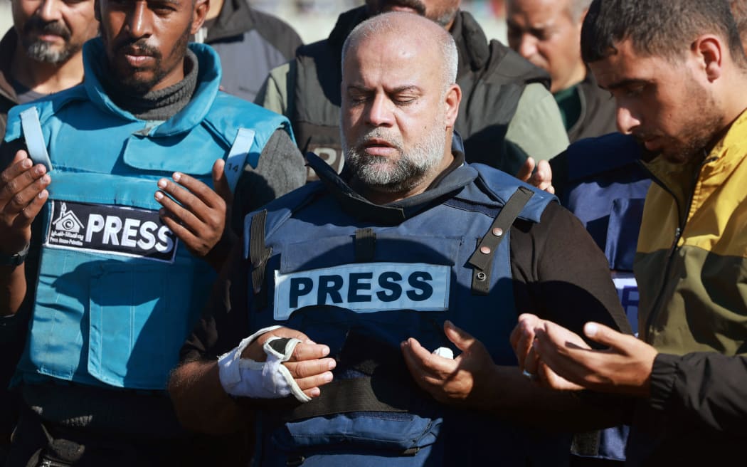 Al Jazeera's bureau chief in Gaza, Wael Al-Dahdouh (C) prays during the funeral of his son Hamza Wael Dahdouh, a journalist with the Al Jazeera television network, who was killed in a reported Israeli air strike in Rafah in the Gaza Strip on January 7, 2024. Dahdouh, who was himself wounded in the arm, lost his wife and two other children in Israeli bombardment in the initial weeks of the war. (Photo by Mohammed ABED / AFP)