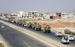 Turkish forces are seen in a convoy on a main highway between Damascus and Aleppo, near the town of Saraqib in the northern Idlib province.