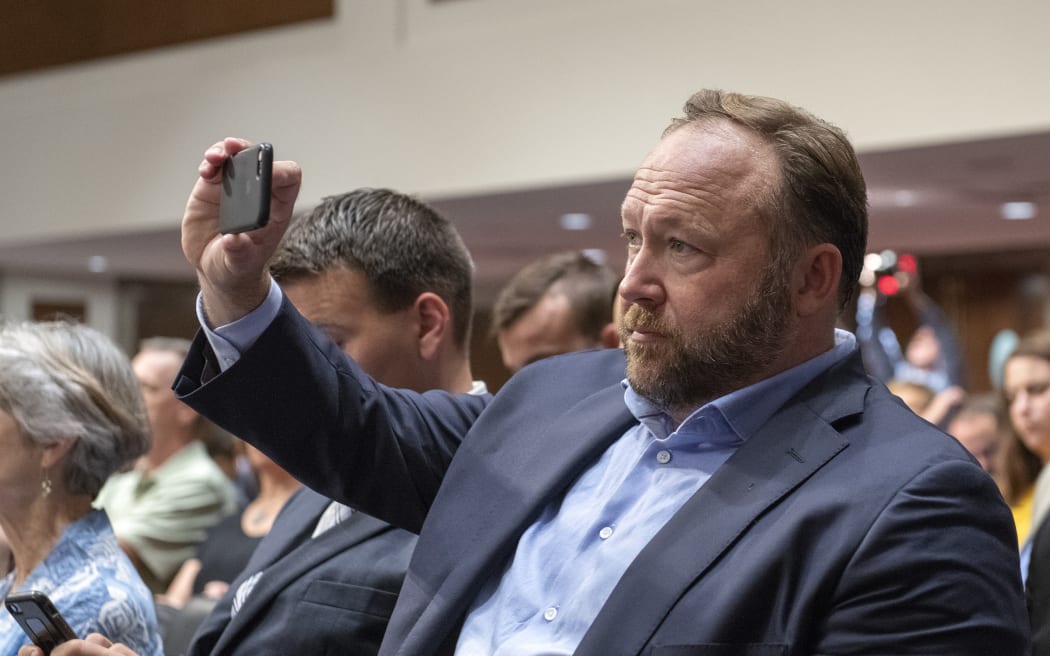 "Infowars" host Alex Jones makes his own recording as he attends the United States Senate Select Committee on Intelligence hearing "to examine foreign influence operations' use of social media platforms" on Capitol Hill in Washington, DC.