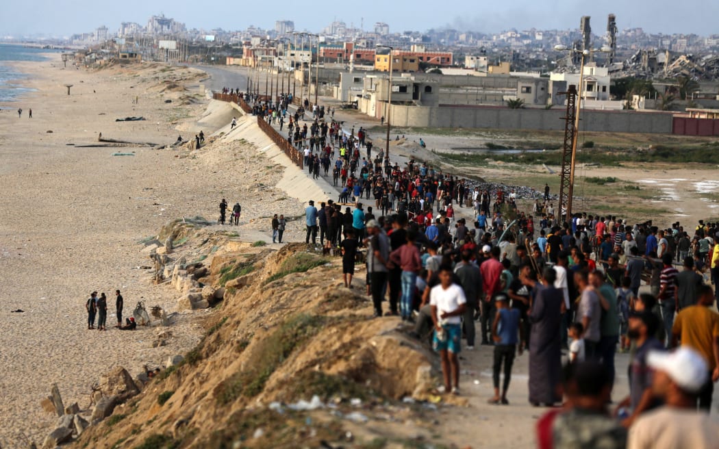 Palestinians are gathering in the hope of obtaining aid delivered into Gaza through a U.S.-built pier, amid the ongoing conflict between Israel and the Palestinian Islamist group Hamas, as seen from central Gaza Strip, on May 19, 2024.