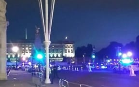 This picture taken from the Twitter account of Matt Vincent, shows policemen guarding the streets outside Buckingham Palace in London.