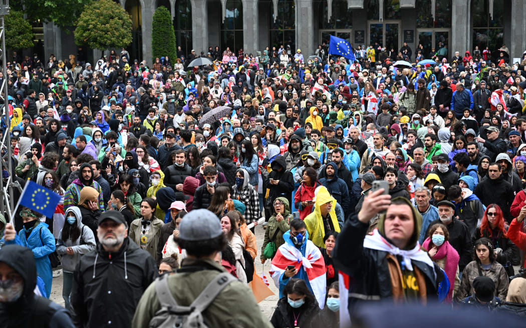 Georgian protesters rally against the controversial "foreign influence" bill in front of the parliament in Tbilisi on May 14, 2024. Georgia's parliament on May 14, 2024 adopted a controversial "foreign influence" law that has sparked weeks of mass protests against the measure, denounced as mirroring Russian legislation used to silence dissent. The bill requires non-governmental organisations and media outlets that receive more than 20 percent of their funding from abroad to register as bodies "pursuing the interests of a foreign power." (Photo by Vano SHLAMOV / AFP)