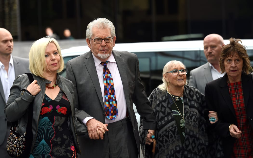 Rolf Harris arrives at court with daughter Bindi (left) and wife Alwen Hughes (second right) on Friday.