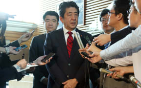 Japan's Prime Minister Shinzo Abe (centre) speaks to reporters at his official residence in Tokyo after the latest test.