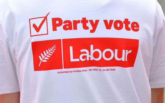 A young Labour supporter waits for the leader of the Labour Party Jacinda Ardern to arrive during a visit to a medical centre on the Labour Party's campaign trail in Wellington on September 19, 2017.