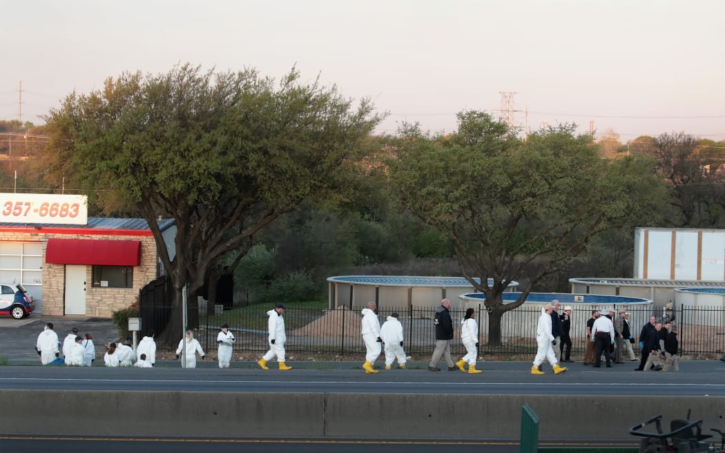 MARCH 21: Law enforcement officials search for evidence at the location where the suspected package bomber was killed in suburban Austin on March 21, 2018 in Round Rock, Texas. Mark Anthony Conditt, the 24-year-old suspect, blew himself up inside his vehicle