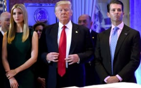 US President- elect Donald Trump stands with his children Ivanka and Donald Jr., during Trump's press conference at Trump Tower in New York on January 11, 2017.
