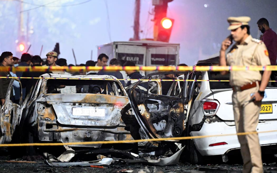 Teams from the National Security Guard, National Investigation Agency, forensic department and Delhi team investigate the site where a blast occurred near the Red Fort, on 10 November, in New Delhi, India.