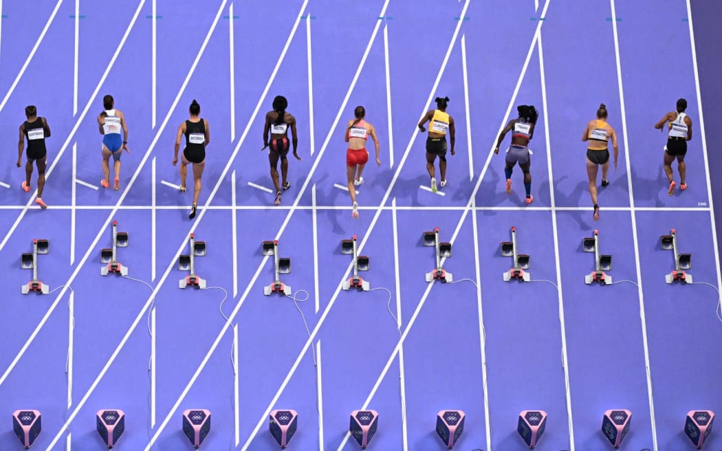 Trinidad and Tobago's Leah Bertrand, Czech Republic's Karolina Manasova, New Zealand's Zoe Hobbs, Britain's Daryll Neita, Canada's Audrey Leduc, Jamaica's Tia Clayton, US' Twanisha Terry, Germany's Gina Lueckenkemper and Belgium's Delphine Nkansa take the start in the women's 100m semi-final of the athletics event at the Paris 2024 Olympic Games at Stade de France in Saint-Denis, north of Paris, on August 3, 2024. (Photo by Antonin THUILLIER / AFP)