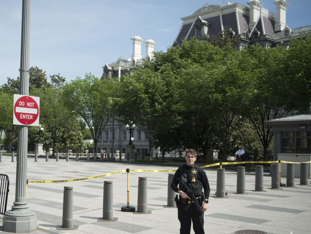 A secret service officer patrols near the Eisenhower Executive Office Building on May 20, 2016 in Washington,DC.