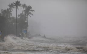People take shelter from heavy rain at Kuakata Sea coast ahead of cyclone Remal's landfall in Kuakata, Bangladesh, on May 26, 2024. According to local authorities, an intense cyclone smashed into the low-lying coast of Bangladesh on Sunday, and at least 800,000 people evacuated their homes in low-lying coastal areas of Bangladesh as the intense cyclone made landfall. (Photo by K M Asad / Middle East Images / Middle East Images via AFP)