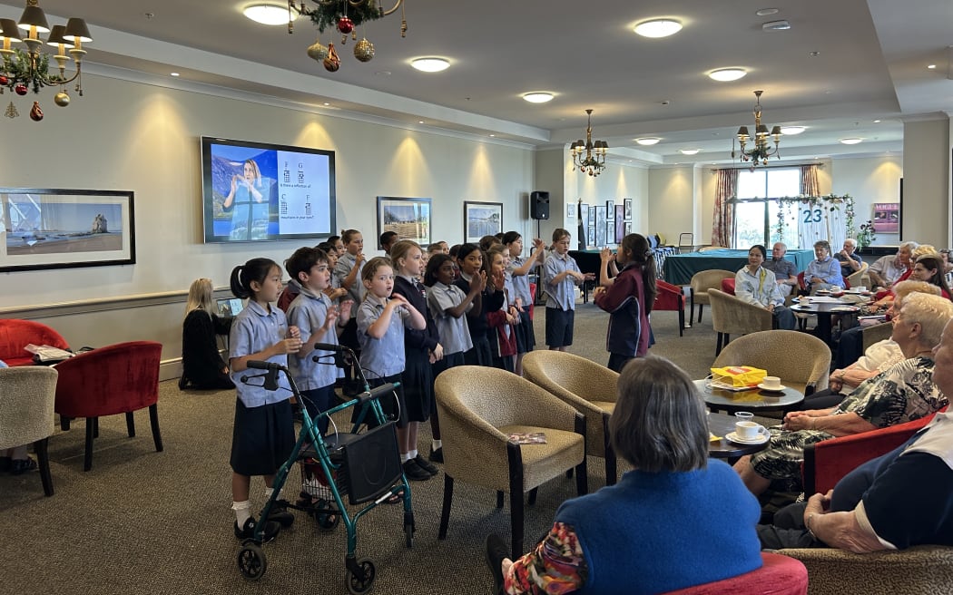 Photo of a group performing sign language songs.