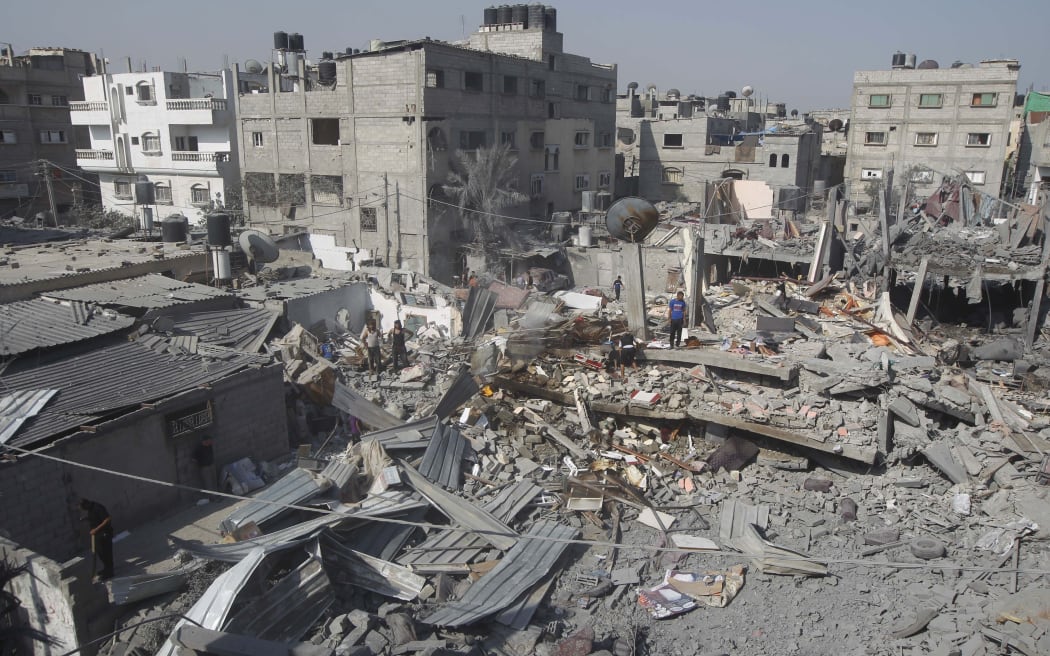 Palestinians inspect the wreckage of a building hit in an Israeli air strike in Rafah, in the southern Gaza Strip.