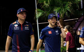 Max Verstappen (L) and Liam Lawson.