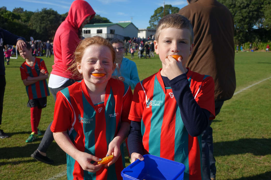 Siblings Jaimee, left, and Riley Seddon enjoy half-time oranges at the Central Football junior tournament at Peringa Park