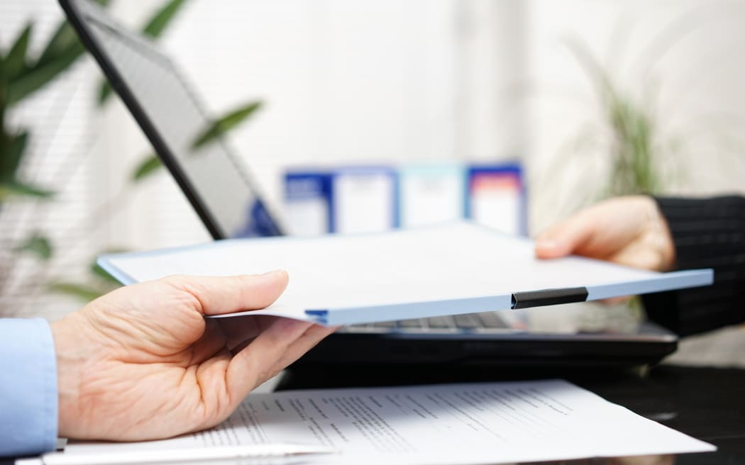 businessman and businesswoman are exchanging document or contract