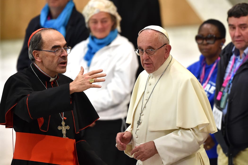 Pope Francis (R) listens to French Cardinal Philippe Barbarin, who was convicted for his role in covering up the sexual abuse of minors.