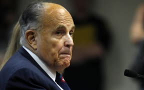 (FILES) In this file photo Rudy Giuliani, former personal lawyer of US President Donald Trump, looks on during an appearance before the Michigan House Oversight Committee in Lansing, Michigan on December 2, 2020.