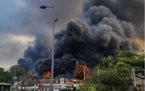 A large plume of black smoke in New Caledonia during civil unrest.