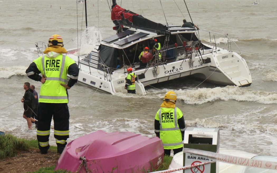 Firefighters save a catamaran that ran aground at Paihia during a previous easterly storm in 2023.