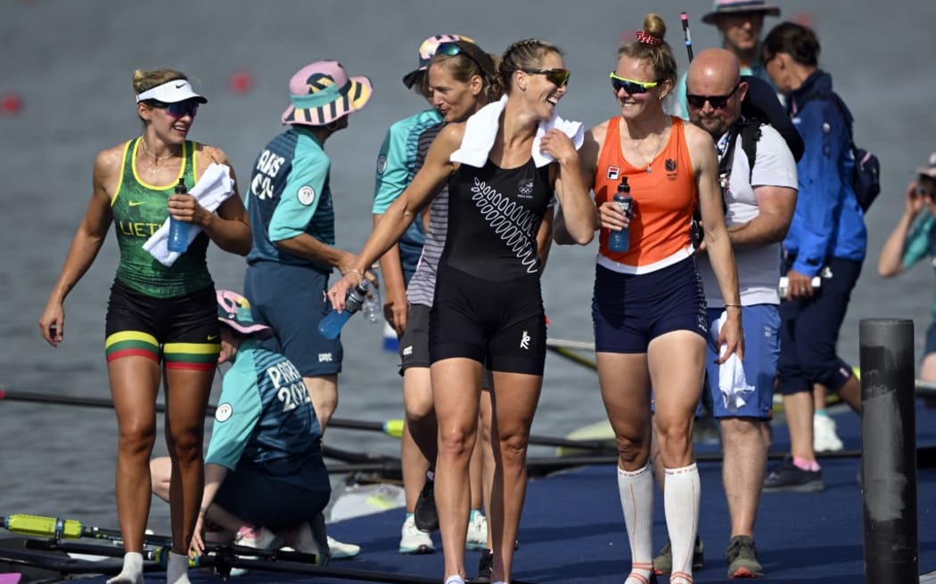 Netherlands' gold medallist Karolien Florijn (R), New Zealand's silver medallist Emma Twigg and Lithuania's bronze medallist Viktorija Senkute (L) leave after competing in the women's single sculls final rowing competition at Vaires-sur-Marne Nautical Centre in Vaires-sur-Marne during the Paris 2024 Olympic Games on August 3, 2024. (Photo by Olivier MORIN / AFP)