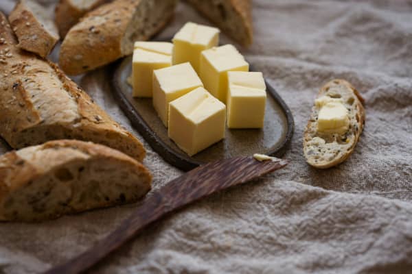 Cubes of butter and sliced baguette