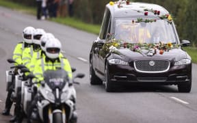 The hearse transporting the coffin of Queen Elizabeth II drives along Albert Road on the day of her state funeral and burial, in Windsor on September 20, 2022.