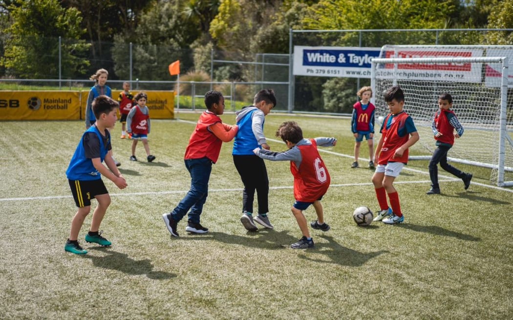 Children kicking a ball around during the New Zealand Police v Community football match.