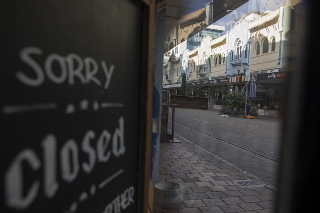 A closure sign is displayed on a shop in an empty street in Christchurch, New Zealand, on April 16, 2020.
