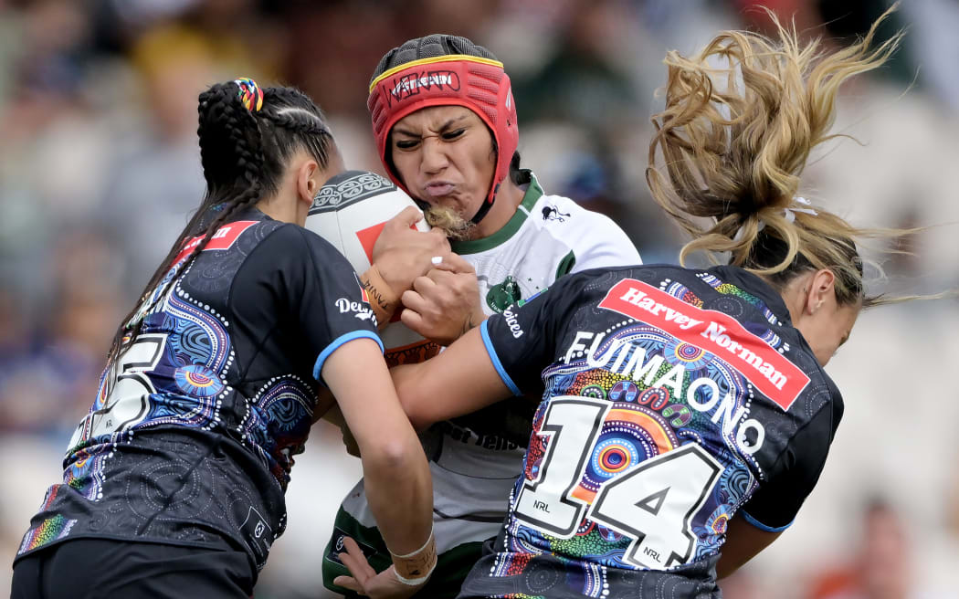 Harata Butler of Maori All Stars Women is tackled.
