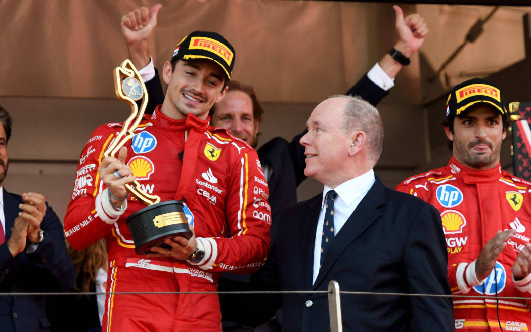Charles Leclerc of Ferrari celebrates 2024 Monaco F1 GP win with Prince Albert II.