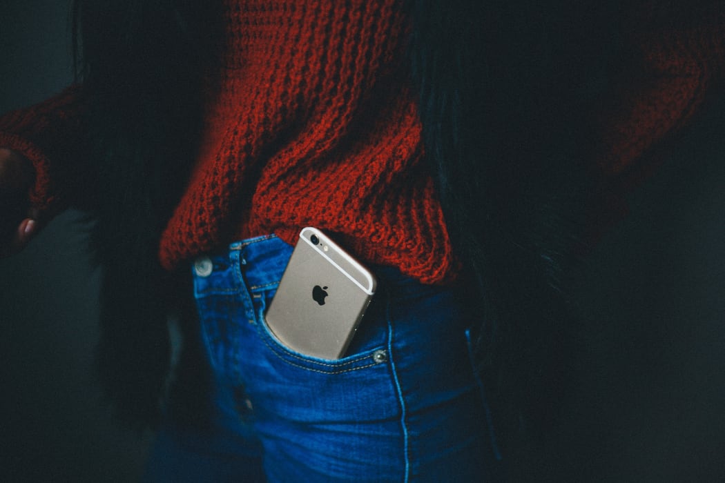 woman with iphone in jeans pocket